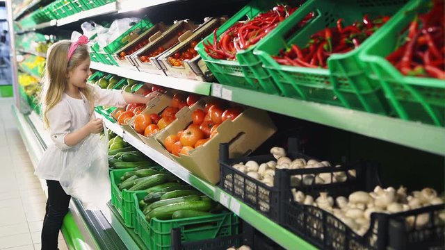 Young girl independently buys food at a supermarket