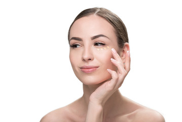 Fototapeta premium Happy beautiful girl putting decorative visage cosmetic