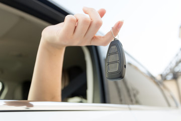 Closeup of car keys hanging on female finger