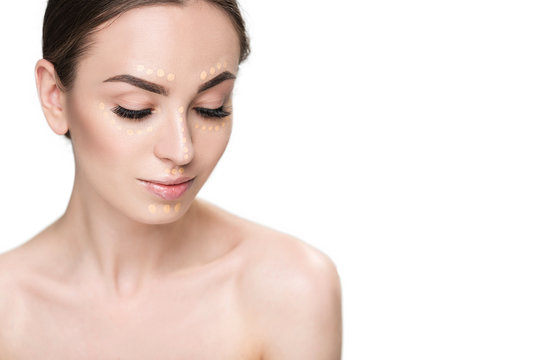 Beautiful young lady presenting concealer