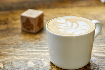 Cup of latte macro. Coffee on blurred background.