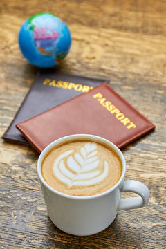 Coffee and passports. Latte cup with flower art.