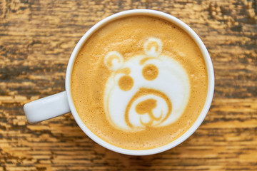 Bear latte art. Coffee cup top view.