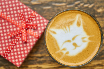 Cat latte art top view. Coffee and gift box.