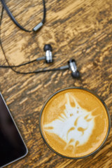 Coffee and earphones. Latte art cat face. Music to wake up to.
