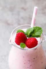 Raspberry milk shake with mint decor.