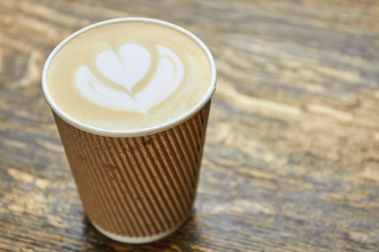 Latte Art In Paper Cup. Coffee Foam Flower Symbol.