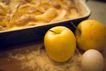 Closeup of freshly made apple and golden apples on kitchen table