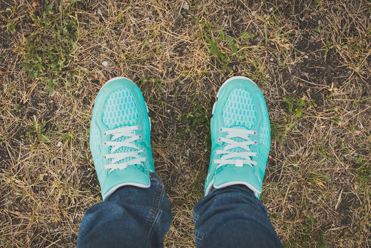 Closeup of running shoes on grass - concept image