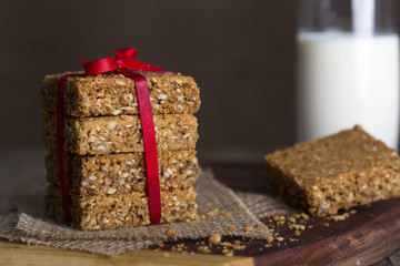 Stack of oatmeal crunchy cookies and milk in background
