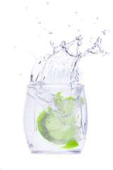 Green fruit in a glass with water