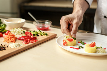  Mature man professional chef cooking meal indoors