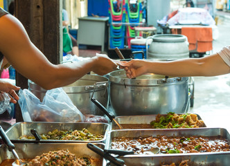 sale, retale, shopping and food concept - close up of hands giving money at street market. Payment...