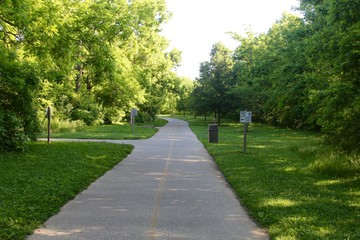 The long sidewalk in the park.