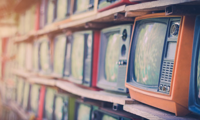 A lot of colorful old television decorate in coffee shop vintage tone.
