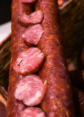Food plat with delicious salami, pieces of sliced ham, sausage, cooked in a traditional way.