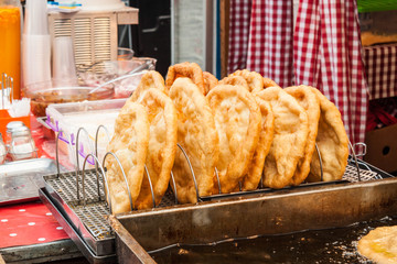 Traditional hungarian fried bread langos sold at a street vendor - 162146119