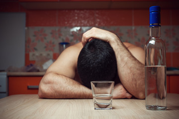 Alcohol addicted man sleeping at the table