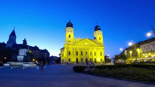 Kossuth square with Protestant Reformed Great Church (Hungarian: Reformatus Nagytemplom) and statue of Lajos Kossuth (on the left), Debrecen city, Hungary. Time Lapse