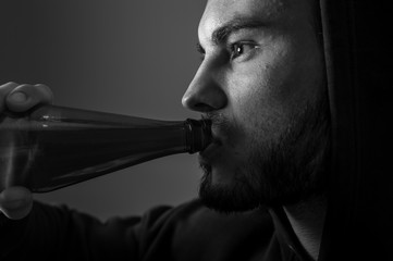 Cropped shot of male adult drinking beer