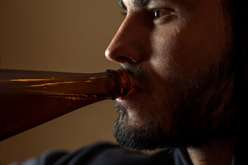 Young drunken man with beer bottle
