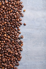 Roasted coffee beans on a grey table