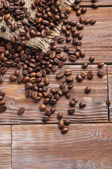 Roasted coffee beans on a brown wooden table