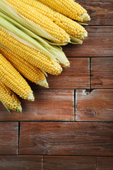 Sweet corns on a brown wooden table