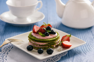 Homemade spinach cake with strawberry mousse
