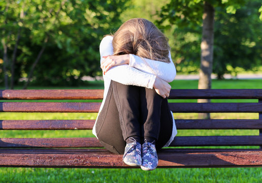 Sad Girl Sitting On A Bench