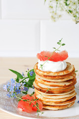 stack of pancakes on a ceramic plate
