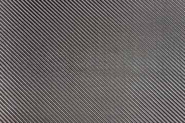 Black woven carbon fiber composite texture for reinforcement car parts.