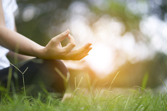 Woman relaxing Yoga in the park, Meditation for peace of mind.