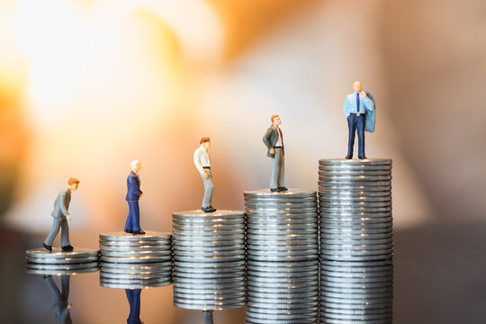 Money, Financial, Business Growth concept, Group of businessman miniature figures walking and looking to a man on top of stack of coins