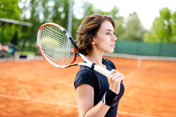 Beautiful young girl on the open tennis court