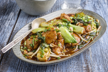 Traditional chicken gung bao with vegetable as close-up on a plate