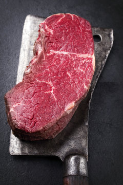 Dry aged raw Kobe Point Steak as close-up on a kitchen cleaver