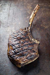 Barbecue dry aged Wagyu Tomahawk Steak as close-up on old metal sheet