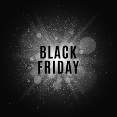 Obraz premium Black Friday. Text on the background of a white flash with luminous dust. Cover for the project. Vector illustration