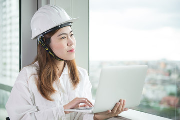 Engineer woman is enjoy working with laptop.