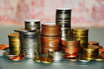 Coins stacked against.Coin groups for save money.Abstract blurry background.