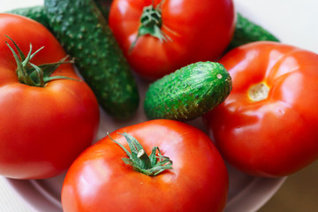 Fresh, ripe red tomatoes and pickled cucumbers.