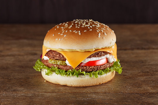 Fresh tasty burger on wooden board