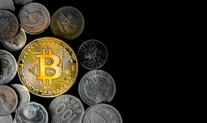 Golden Bitcoin surrounded by coins from various countries, on black background. Flat lay with copy space