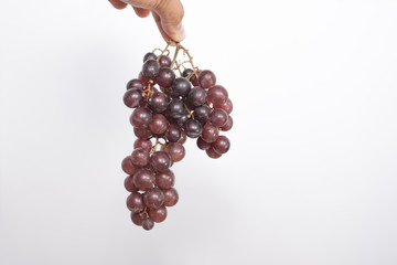 Grapes in hand on a white background.