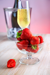 strawberries in a glass vase stands on the table
