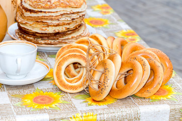 Traditional Russian food during the pancake week or maslenitsa. Pancakes and bagels on the table