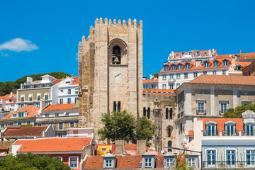 Fototapeta na wymiar Tower bells of patriarchal Cathedral of St. Mary Major (Santa Maria Maior de Lisboa) and red roofs in Lisbon, Portugal 