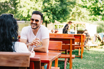 Fototapeta premium Dating couple talking and relaxing together in a street cafe