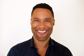 Close up african american young man smiling against white background